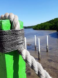 Close-up of rope tied on wooden post