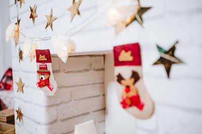 Christmas decoration at home. chimney, gifts, tree, noel, cushions on beautiful indoor white studio.