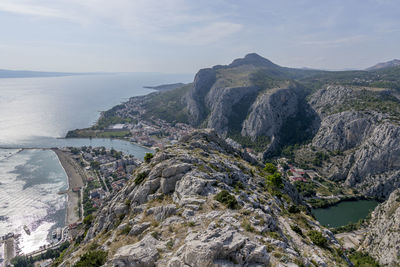 Scenic view of sea and mountains against sky