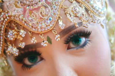 Close-up portrait of beautiful young woman wearing make-up and jewelries