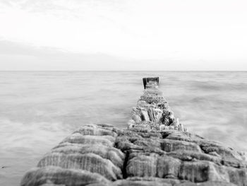 Scenic view of rocks on beach against sky