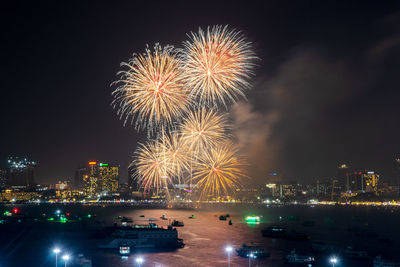 Fantastic and colorful fireworks display over the night sky of the city during a festival