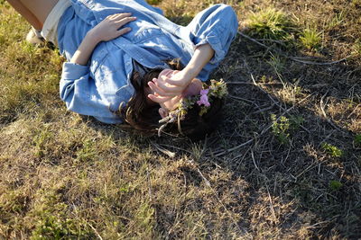 Low section of women sitting on field