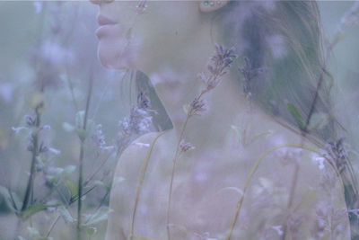 Close-up of woman with pink flowering plants