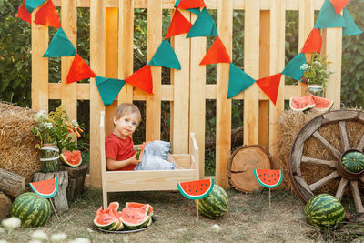 Full length of boy sitting on table