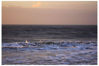 Scenic view of sea against sky at sunset