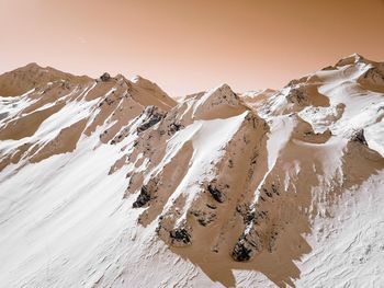 Scenic view of snowcapped mountains against clear sky