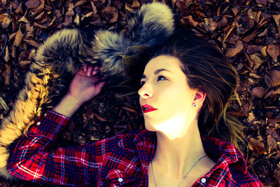 Directly above shot of young woman lying on field