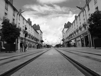 Surface level of street amidst buildings against sky