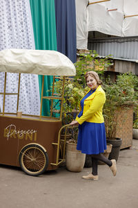 Side view of young woman standing in market