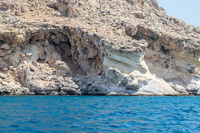 Scenic view of rocks in sea against sky