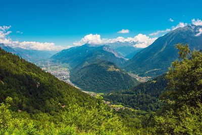 Scenic view of mountains against blue sky