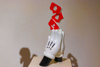 Close-up of stuffed toy on table against wall