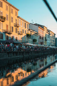 Reflection of buildings in water against clear sky