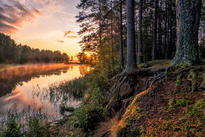 Scenic view of lake against sky at sunset