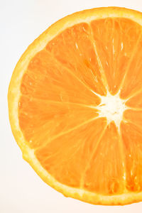 Close-up of orange slice against white background