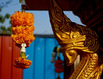 Close-up of buddha statue against wall of building