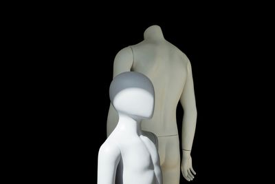 Close-up of mannequins against black background