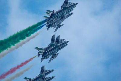 Low angle view of airplane flying against sky