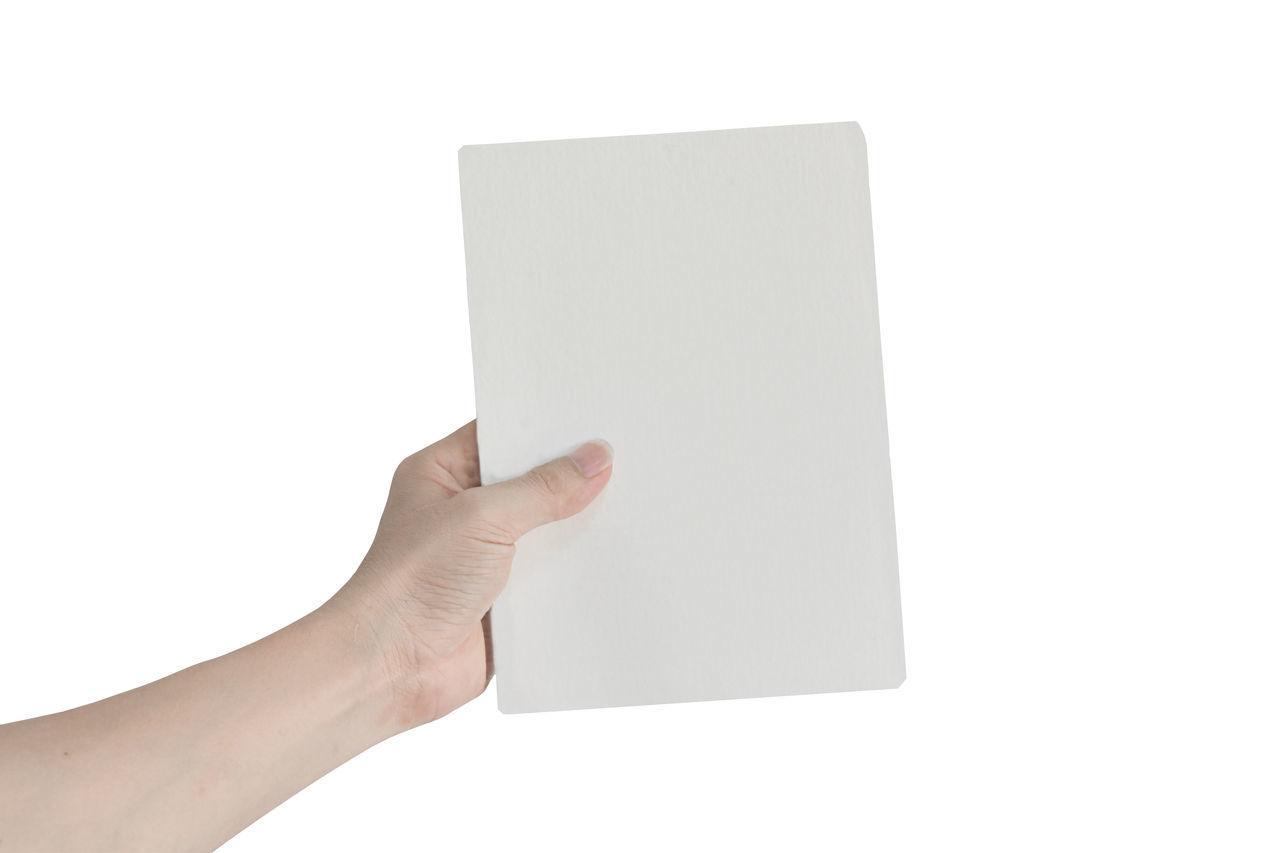 CLOSE-UP OF HUMAN HAND HOLDING PAPER AGAINST WHITE BACKGROUND
