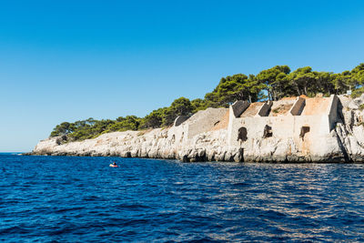 Scenic view of sea against clear blue sky