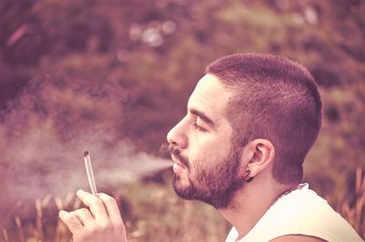 Close-up of man smoking cigarette