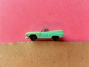 High angle view of toy car against pink background