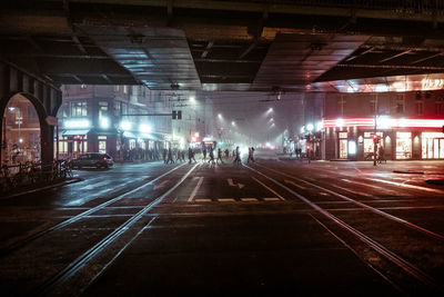 People in illuminated city at night