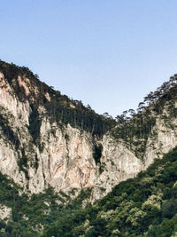 Scenic view of rocky mountains against clear sky