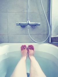 Low section of woman legs in bathroom