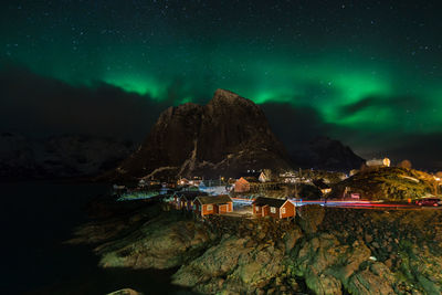 Scenic view of illuminated mountains against sky at night