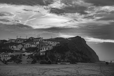 View of beach against cloudy sky