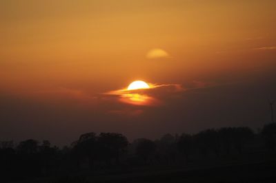 Scenic view of silhouette landscape against romantic sky at sunset