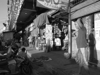 People at market stall in city