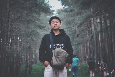 Full length of young man looking at forest