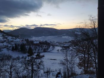 Scenic view of snowcapped mountains against sky during sunset