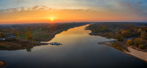 Scenic view of river against sky during sunset