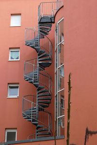 Low angle view of spiral staircase against building /  fire escapes / escape stairs