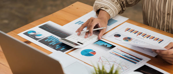 High angle view of woman using laptop on table