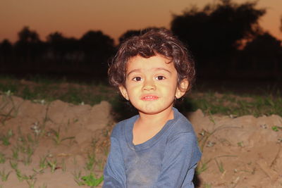 Portrait of cute boy standing on field