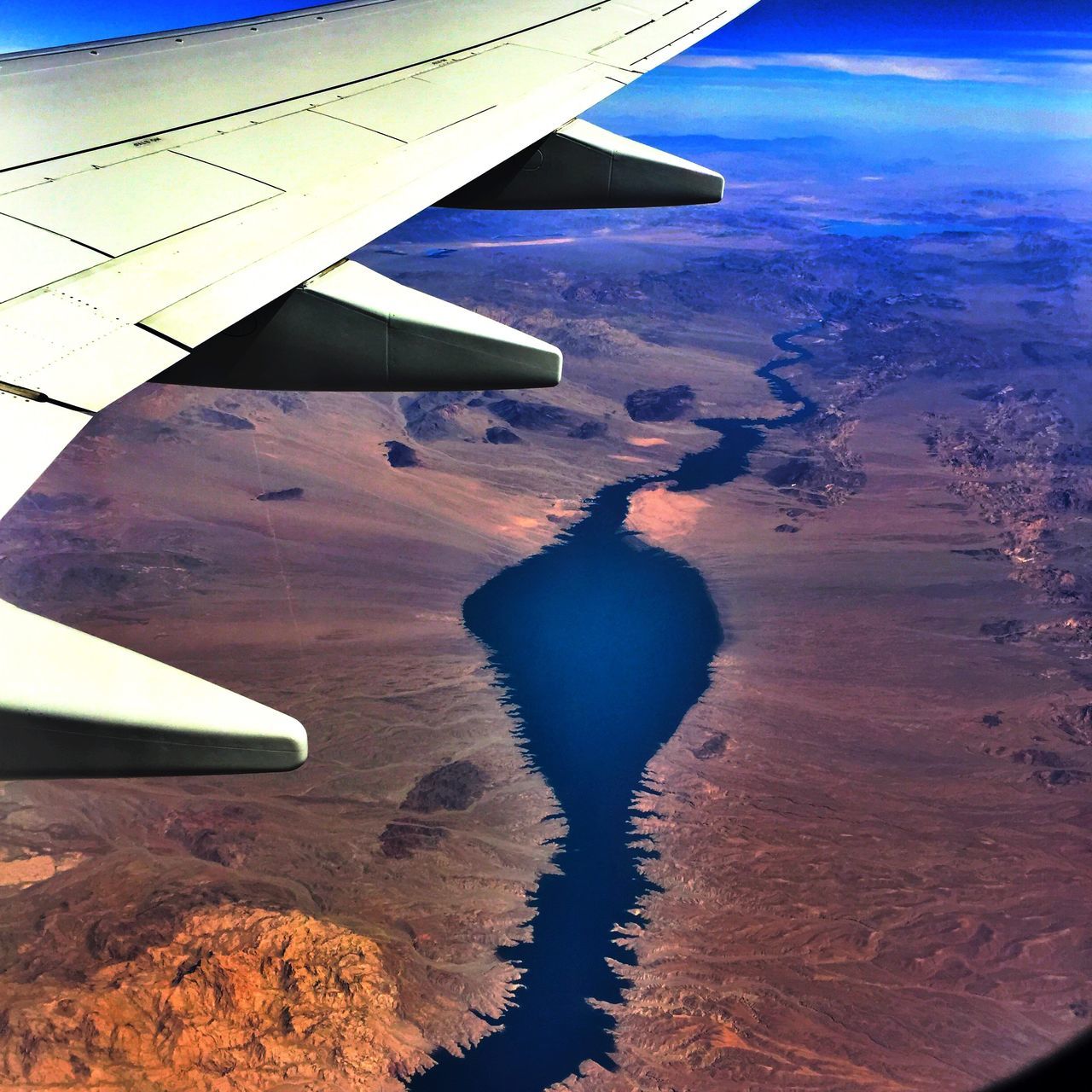 transportation, aircraft wing, airplane, mode of transport, flying, air vehicle, part of, cropped, aerial view, sea, travel, mid-air, water, sky, nautical vessel, journey, scenics, blue, beauty in nature, nature