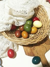 High angle view of easter eggs in wicker basket on table