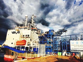 Harbor against cloudy sky