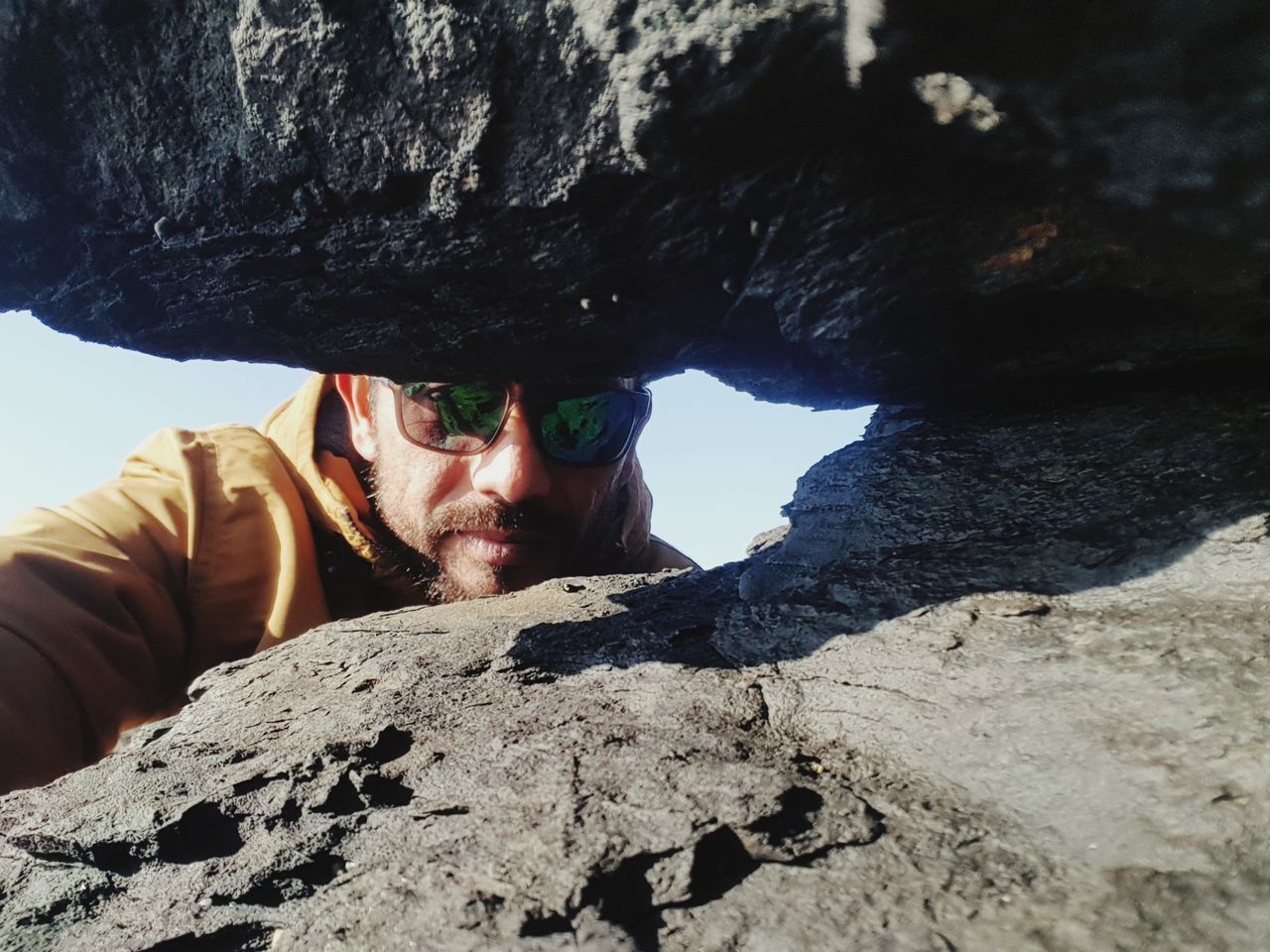 real people, men, rock, lifestyles, solid, leisure activity, rock - object, people, nature, rock formation, day, front view, portrait, males, adult, clothing, outdoors, headshot, warm clothing