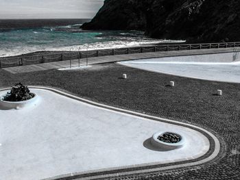 High angle view of swimming pool by sea against sky