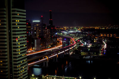 High angle view of illuminated cityscape against sky at night