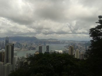 Cityscape against cloudy sky