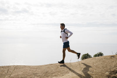 Full length of man running on beach