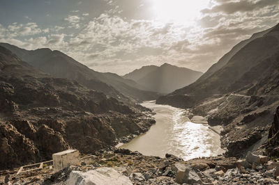 Scenic view of river amidst mountains against sky