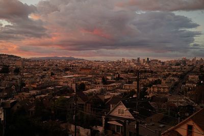 Cityscape against cloudy sky